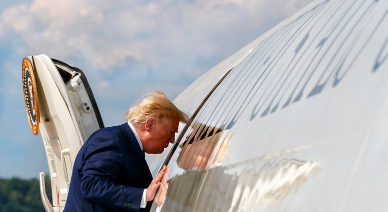 President Donald Trump boards Air Force One, Friday, Aug. 2, 2019, at Andrews Air Force Base, Md., en route to New Jersey. (AP Photo/Jacquelyn Martin)