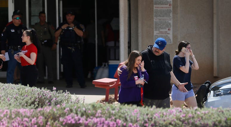 People arrive at MacArthur Elementary looking for family and friends during the aftermath of a shooting at the Walmart near the Cielo Vista Mall, Saturday, Aug. 3, in El Paso, Texas. (Briana Sanchez/The El Paso Times via AP)
