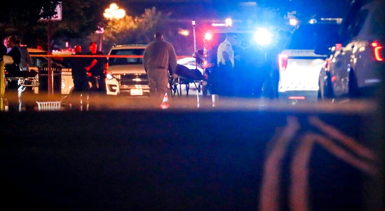 Bodies are removed from at the scene of a mass shooting, Sunday, Aug. 4, 2019, in Dayton, Ohio. Several people in Ohio have been killed in the second mass shooting in the U.S. in less than 24 hours, and the suspected shooter is also deceased, police said.