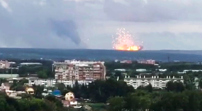 In this image taken from video, explosions are seen at the military base, about 10 kilometers from Achinsk, Krasnoyarsk region, Russia Far East, Monday, Aug. 5, 2019. An explosion at a Russian military base in Siberia has set off fires and injured at seve