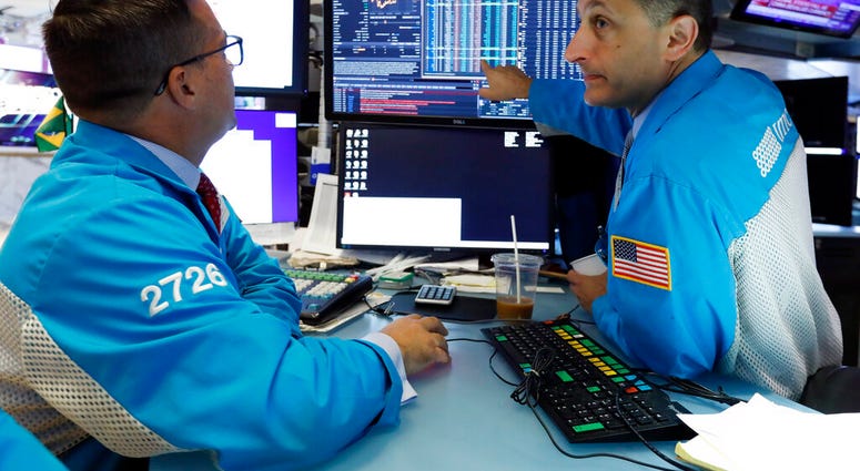 Specialists Paul Cosentino, left, and Jeffrey Berger work on the floor of the New York Stock Exchange, Monday, Aug. 5, 2019. U.S. stocks nosedived in early trading on Wall Street Monday as China's currency fell sharply and stoked fears that the trade wa