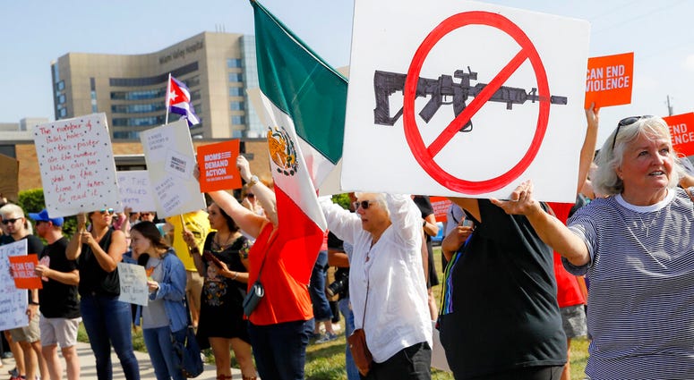 Demonstrators gather to protest the arrival of President Donald Trump outside Miami Valley Hospital after a mass shooting that occurred in the Oregon District early Sunday morning, Wednesday, Aug. 7, 2019, in Dayton. President Donald Trump is headed to Da