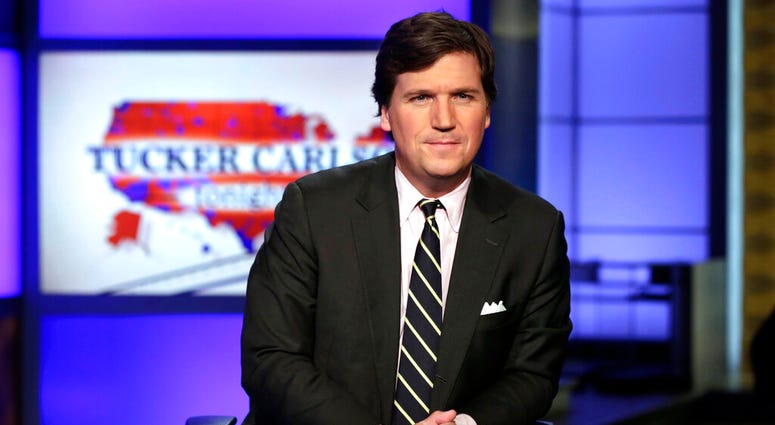 FILE - In this March 2, 2017 file photo, Tucker Carlson, host of "Tucker Carlson Tonight," poses for photos in a Fox News Channel studio, in New York. Carlson faced criticism Wednesday, Aug. 7, 2019, for declaring white supremacy "a hoax," the same day Pr
