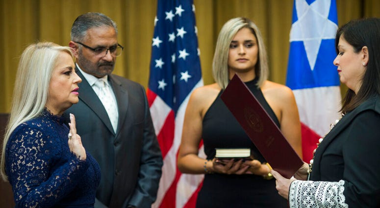 Justice Secretary Wanda Vazquez is sworn in as governor of Puerto Rico by Supreme Court Justice Maite Oronoz, in San Juan, Puerto Rico, Wednesday, Aug. 7, 2019. Vazquez took the oath of office early Wednesday evening at the Puerto Rican Supreme Court, whi