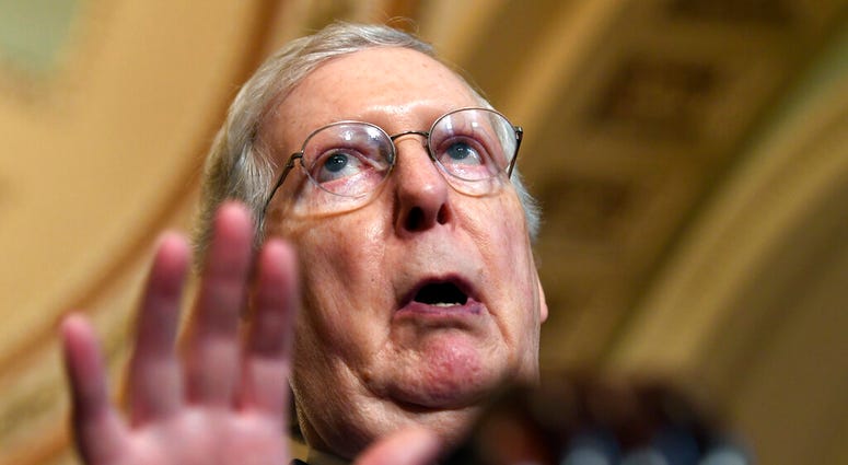 FILE - In this July 23, 2019, file photo, Senate Majority Leader Mitch McConnell of Ky., speaks to reporters on Capitol Hill in Washington. More than 200 mayors, including the mayors of El Paso, Texas and Dayton, Ohio, are urging Senate leaders to call se