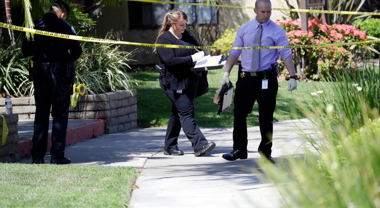 Police investigate the scene where two people were stabbed to death Thursday, Aug. 8, 2019, in Garden Grove, Calif. A man killed four people and wounded two in a string of robberies and stabbings in California's Orange County before he was arrested, polic