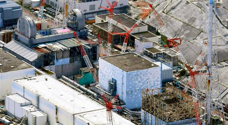 FILE - This Sept. 4, 2017, aerial file photo shows Fukushima Dai-ichi nuclear power plant reactors, bottom from right, Unit 1, Unit 2 and Unit 3, in Okuma town, Fukushima prefecture, northeastern Japan. The utility company operating Fukushima's tsunami-wr