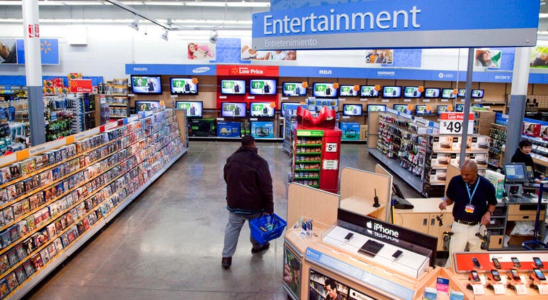 FILE = In this Dec. 15, 2010 file photo, a view of the entertainment section of a Wal-Mart store is seen in Alexandria, Va. Walmart is taking down all signs and displays from its stores that depict violence, following a mass shooting at its El Paso, Texas