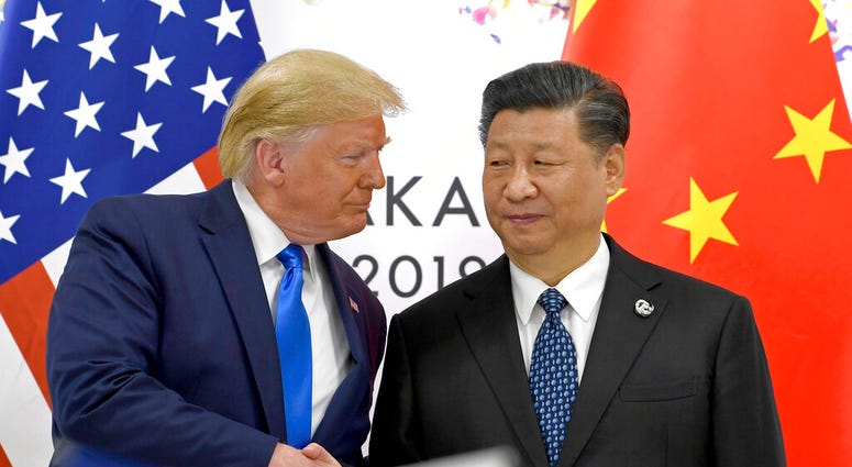 FILE - In this June 29, 2019, file photo, U.S. President Donald Trump, left, shakes hands with Chinese President Xi Jinping during a meeting on the sidelines of the G-20 summit in Osaka,