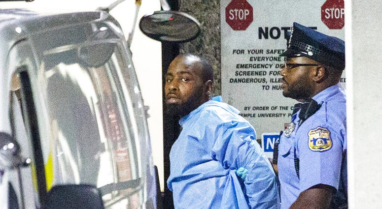 Police take shooting suspect, Maurice Hill, into custody after an hourslong standoff with police, that wounded several police officers, in Philadelphia early Thursday, Aug. 15, 2019. (Elizabeth Robertson/The Philadelphia Inquirer via AP)