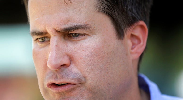 Democratic presidential candidate Rep. Seth Moulton, D-Mass., speaks with reporters, Sunday, Aug. 18, 2019, at the Hillsborough County Democrats Summer Picnic, in Greenfield, N.H. (AP Photo/Steven Senne)