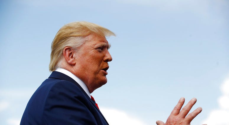 President Donald Trump speaks with reporters before boarding Air Force One at Morristown Municipal Airport in Morristown, N.J., Sunday, Aug. 18, 2019. (AP Photo/Patrick Semansky)