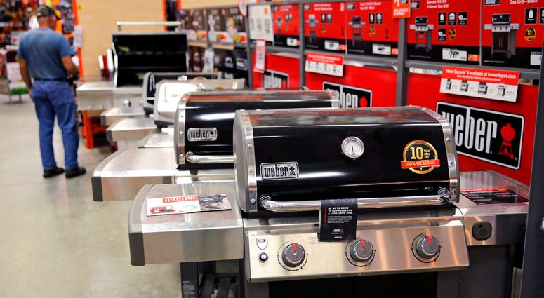 FILE - In this July 11, 2019, file photo Weber grills are displayed at the Home Depot store in Londonderry, N.H. The Home Depot Inc. on Tuesday, Aug. 20, reported fiscal second-quarter net income of $3.48 billion. (AP Photo/Charles Krupa, File)