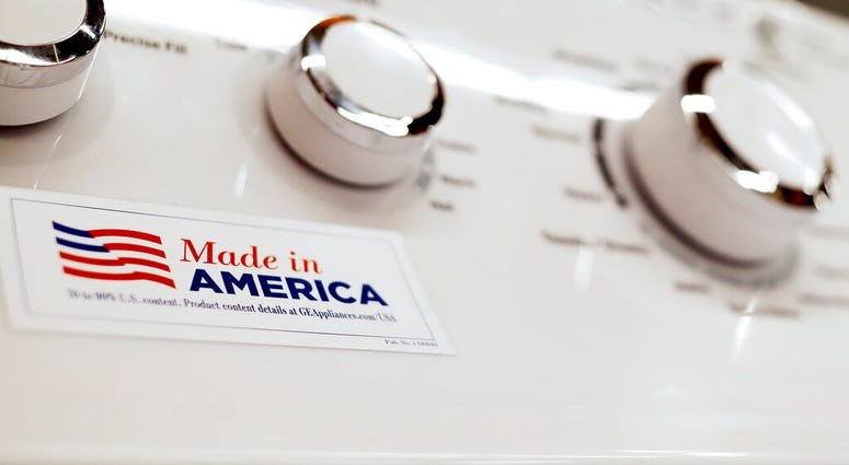 ILE - In this May 9, 2019, file photo a General Electric washing machine with a label advertising it was made in America is displayed in retail stores in Cranberry Township, Pa.