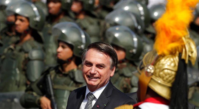Brazils President Jair Bolsonaro arrive to attend a military ceremony for the Day of the Soldier, at Army Headquarters in Brasilia, Brazil, Friday, Aug. 23, 2019. Bolsonaro says he's leaning toward sending the army to help fight Amazon fires that have ala