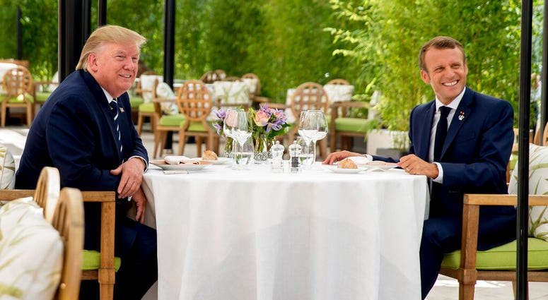 U.S President Donald Trump sits for lunch with French President Emmanuel Macron, right, at the Hotel du Palais in Biarritz, south-west France, Saturday Aug. 24, 2019.