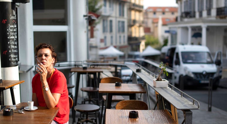 A woman has a cigarette with her morning coffee in Biarritz, France, on the third day of the G-7 summit, Monday, Aug. 26, 2019. (AP Photo/Peter Dejong) A woman has a cigarette with her morning coffee in Biarritz, France, on the third day of the G-7 summit, Monday, Aug. 26, 2019. (AP Photo/Peter Dejong)
