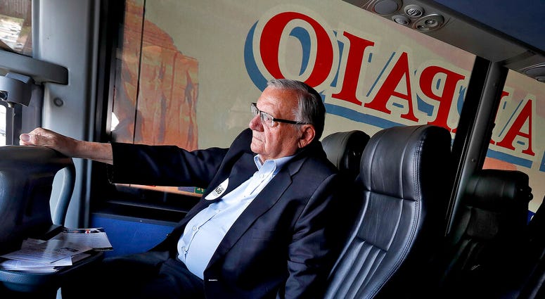 FILE - In this Aug. 23, 2018, file photo U.S. Senatorial candidate and former Maricopa County Sheriff Joe Arpaio rides on his campaign bus in Phoenix.