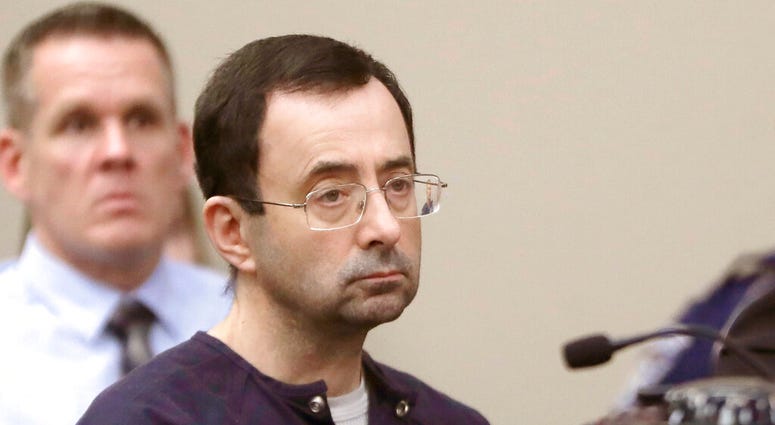 FILE - In this Jan. 24, 2018, file photo, Larry Nassar, a former doctor for USA Gymnastics and member of Michigan State's sports medicine staff, sits in court during his sentencing hearing in Lansing, Mich.
