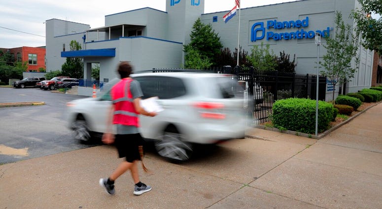 FILE - In this June 21, 2019, file photo, a motorist enters Planned Parenthood of the St. Louis Region and Southwest Missouri. A new Missouri ban on abortions at or after eight weeks of pregnancy won't take effect on August 28 after a federal judge tempor
