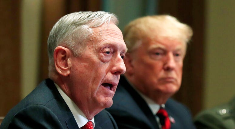 FILE - In this Oct. 23, 2018 file photo, Defense Secretary Jim Mattis speaks beside President Donald Trump, during a briefing with senior military leaders in the Cabinet Room at the White House in Washington.