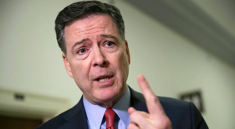 FILE - In this Dec. 17, 2018, file photo, former FBI Director James Comey speaks to reporters on Capitol Hill Washington. The Justice Department’s inspector general says former FBI Director James Comey violated FBI policies in his handling of memos docume