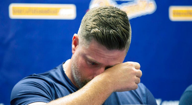Montgomery Biscuits manager Morgan Ensberg wipes away tears during a news conference about pitcher Blake Bivens' wife and child who were killed in a triple homicide, Thursday, Aug. 29, 2019. (Kirsten Fiscus/Montgomery Advertiser via AP)