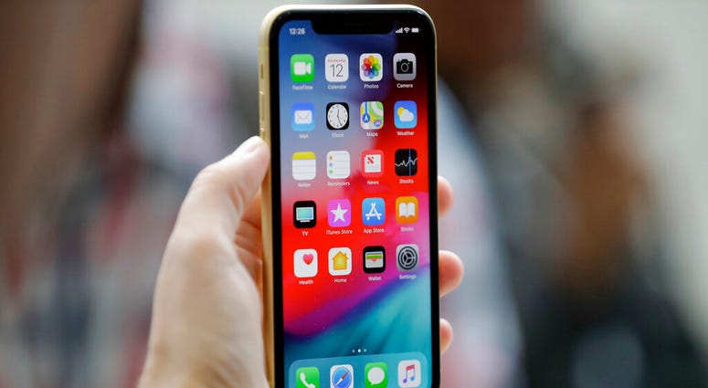 FILE - This Sept. 12, 2018, file photo shows an Apple iPhone XR on display at the Steve Jobs Theater after an event to announce new products, in Cupertino, Calif. Security experts are calling a newly announced security vulnerability the worst yet affectin