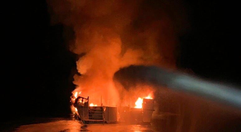 In this photo provided by the Ventura County Fire Department, VCFD firefighters respond to a boat fire off the coast of southern California, Monday, Sept. 2, 2019. The U.S. Coast Guard said it has launched several boats to help over two dozen people "in d