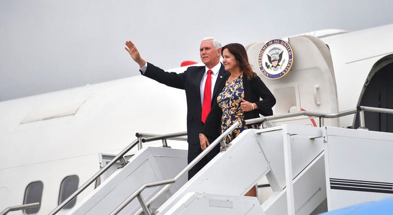 US Vice President Mike Pence and his wife Karen Pence gesture as they arrive at Shannon airport for the start of an official visit to Ireland, Monday, Sept. 2, 2019. (Jacob King/PA via AP)
