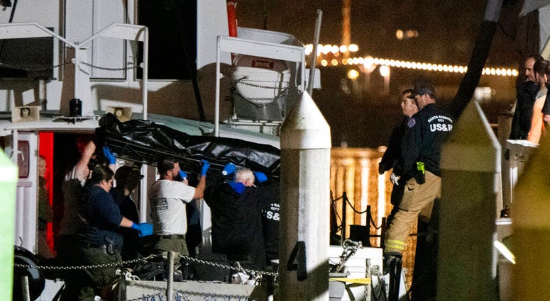 Local law enforcement along with search and rescue teams help unload the bodies of those who died in a diving boat fire, Monday, Sept. 2, 2019, in Santa Barbara, Calif.