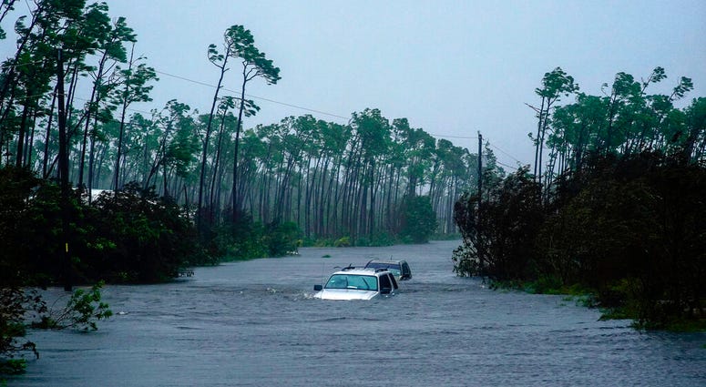 Cars sit submerged in water from Hurricane Dorian in Freeport, Bahamas, Tuesday, Sept. 3, 2019.
