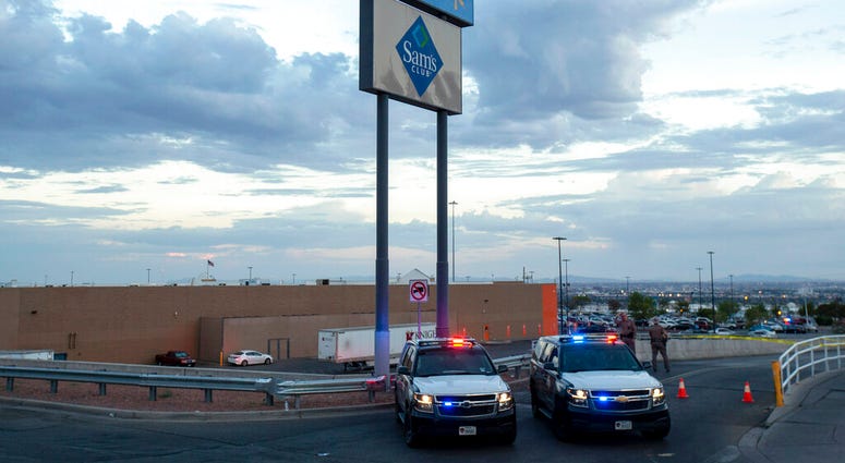 FILE - In this Aug. 3, 2019, photo texas state police cars block the access to the Walmart store in the aftermath of a mass shooting in El Paso, Texas.