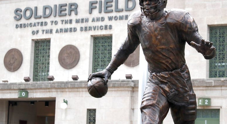 The newly dedicated statue of Chicago Bears and Pro Football Hall of Fame running back Walter Payton stands outside Soldier Field during an unveiling ceremony of statues honoring George Halas and Payton, Tuesday, Sept. 3, 2019, in Chicago.