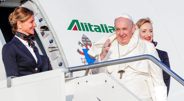 Pope Francis is greeted by a flight attendant as he boards his flight to Maputo, Mozambique, in Rome's Fiumicino International airport, Wednesday, Sept. 4, 2019. (AP Photo/Andrew Medichini) Pope Francis is greeted by a flight attendant as he boards his flight to Maputo, Mozambique, in Rome's Fiumicino International airport, Wednesday, Sept. 4, 2019. (AP Photo/Andrew Medichini)