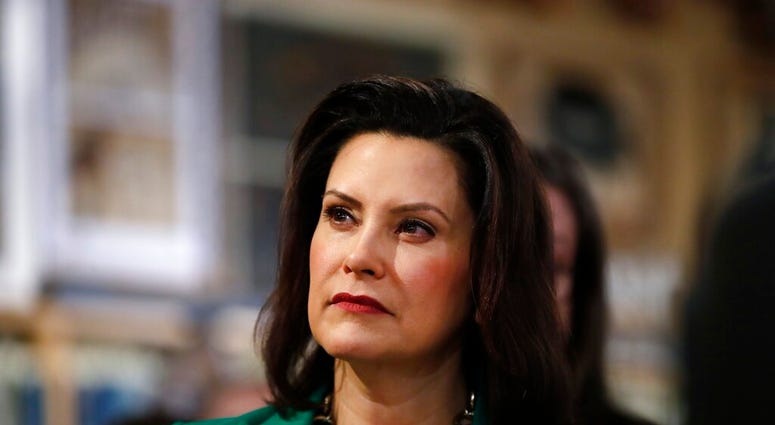 FILE - In this March 18, 2019, file photo, Michigan Gov. Gretchen Whitmer listens to Democratic presidential candidate Sen. Kirsten Gillibrand, D-N.Y., in Clawson, Mich. (AP Photo/Paul Sancya, File) FILE - In this March 18, 2019, file photo, Michigan Gov. Gretchen Whitmer listens to Democratic presidential candidate Sen. Kirsten Gillibrand, D-N.Y., in Clawson, Mich. (AP Photo/Paul Sancya, File)