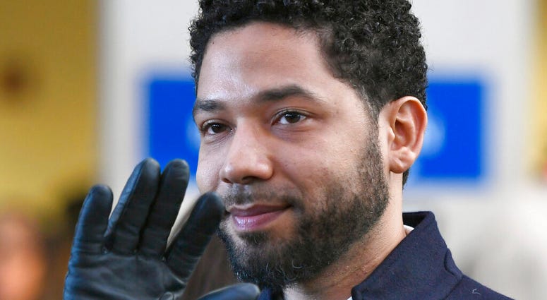 FILE - In this March 26, 2019, file photo, actor Jussie Smollett smiles and waves to supporters before leaving Cook County Court after his charges were dropped in Chicago.