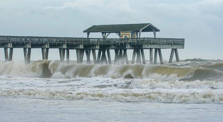 Large waves crashed onto the beach of Tybee Island, Ga., Wednesday, Sept. 4, 2019 as Hurricane Dorian moved closer to the Georgia coast. (Casey Jones/Savannah Morning News via AP)