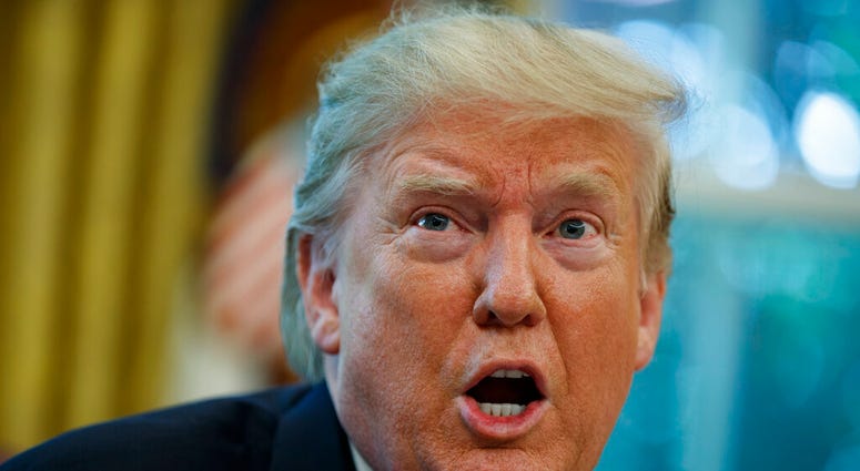President Donald Trump talks with reporters after receiving a briefing on Hurricane Dorian in the Oval Office of the White House, Wednesday, Sept. 4, 2019, in Washington.