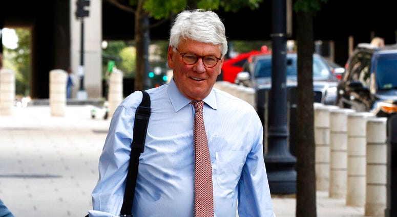 In this Aug. 22, 2019, file photo, Greg Craig, right, former White House counsel to former President Barack Obama, walks into a federal courthouse for his trial, in Washington. (AP Photo/Patrick Semansky, File)