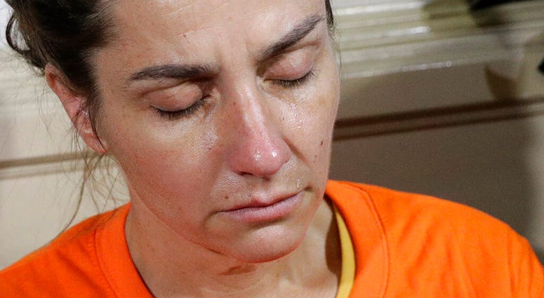A tear rolls on the cheek of American national Jennifer Erin Talbot from Ohio before the start of a press conference by the National Bureau of Investigation (NBI) in Manila, Philippines, Thursday, Sept. 5, 2019.