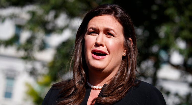 FILE - In this June 11, 2019 file photo, White House press secretary Sarah Sanders talks with reporters outside the White House in Washington.
