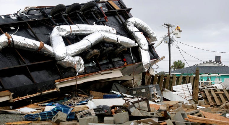 Power company lineman work to restore power after a tornado hit Emerald Isle, N.C. as Hurricane Dorian moved up the East coast on Thursday, Sept. 5, 2019. (AP Photo/Tom Copeland)