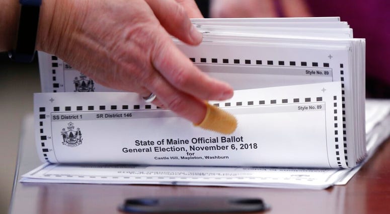 In this Nov. 12, 2018 file photo, ballots are prepared for tabulation in Augusta, Maine, in the Second Congressional District's House election, the first congressional race in American history to be decided by the ranked-choice voting method.