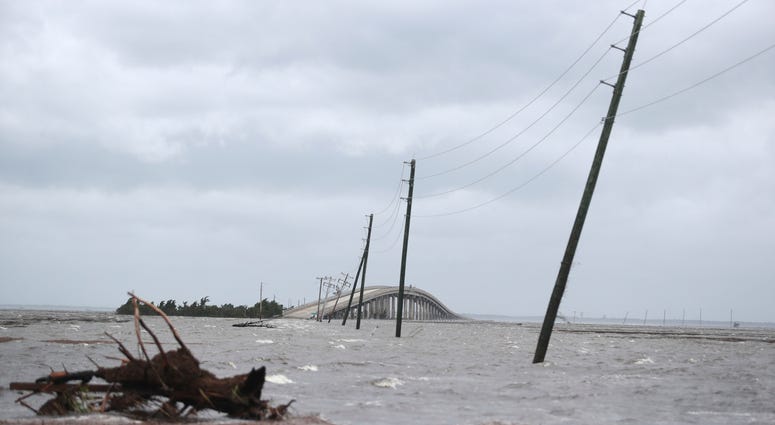 Storm surge from Hurricane Dorian blocks Cedar Island off from the mainland on NC 12 in Atlantic Beach, N.C., after Hurricane Dorian past the coast on Friday, Sept. 6, 2019. (AP Photo/Tom Copeland)