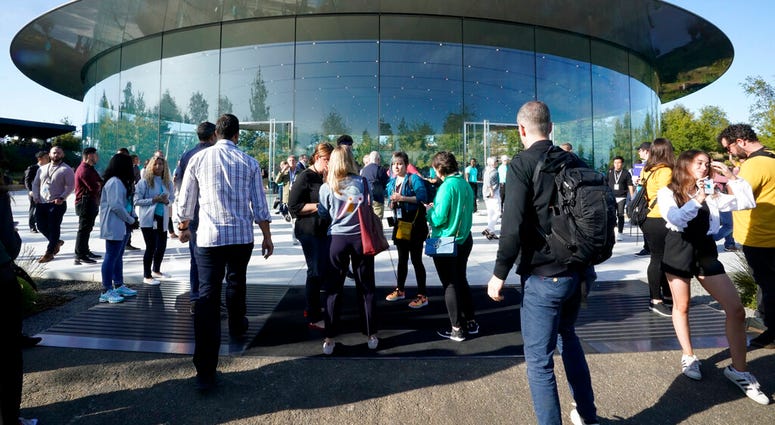 People arrive at Apple for an event to announce new products Tuesday, Sept. 10, 2019, in Cupertino, Calif.