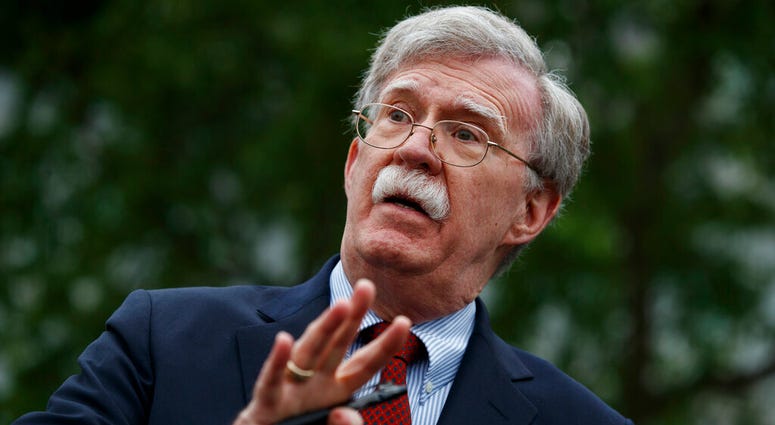 In this May 1, 2019 file photo, National security adviser John Bolton talks to reporters outside the White House in Washington. (AP Photo/Evan Vucci)