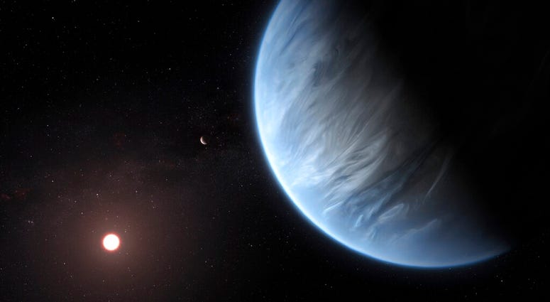 This artist's rendering provided by University College London Centre for Space Exochemistry Data researchers shows Exoplanet K2-18b, foreground, its host star and an accompanying planet in this system.