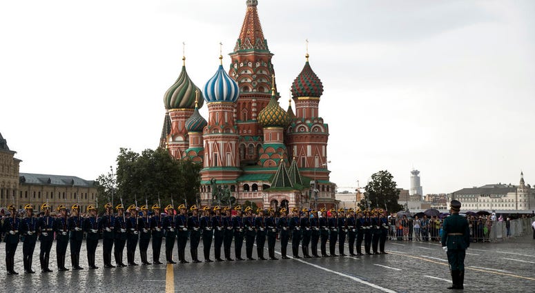 FILE - In this June 30, 2018, file photo, Kremlin guards perform in Red Square with the with St. Basil's Cathedral in the background, in Moscow, Russia.