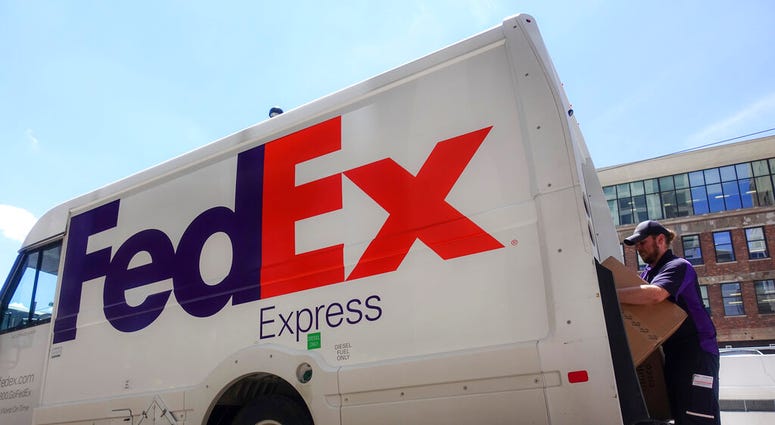 FILE - In this June 25, 2019, file photo a FedEx delivery truck is loaded by an employee on the street in downtown Cincinnati. FedEx reports financial results Tuesday, Sept. 17.